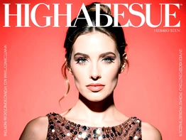 A glamorous close-up portrait of a person in a sequined evening gown posed against a vivid coral-red studio backdrop, styled as the cover of a high-fashion magazine with bold white sans-serif title text at the top and small cover-line text along the sides. Bright beauty lighting from directly above creates a polished, high-contrast look. Style: fashion magazine cover photography. Mood: bold and aspirational.
